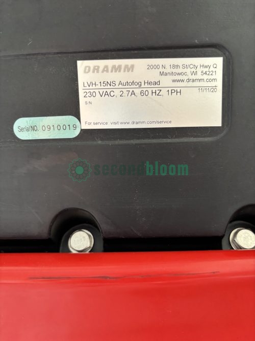 Close-up of black electrical specification label showing voltage and model information