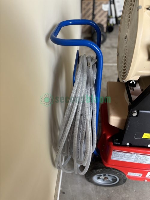 Air hose coiled and stored on blue hose management hook