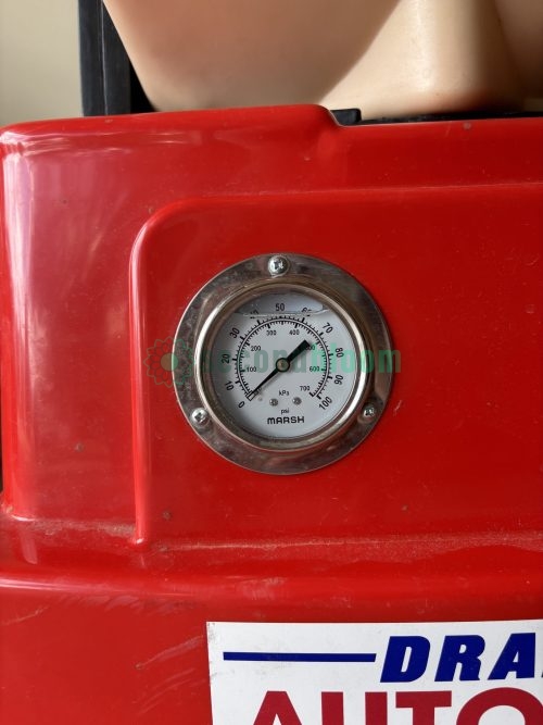 Pressure gauge mounted on red housing showing operational monitoring capability